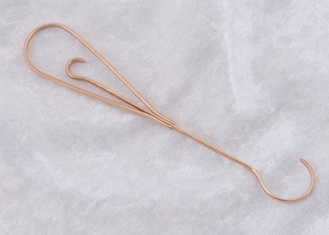 A 10k marked double ended button hook