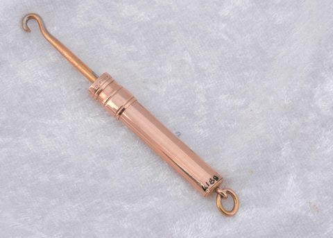 A 14k marked slide button hook