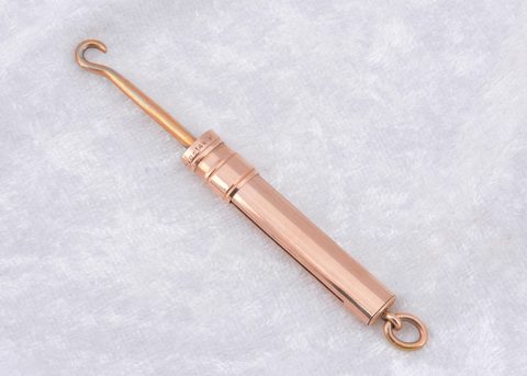A 14k marked slide button hook