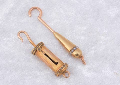 A 19th Century yellow metal and seed pearl decorated sliding button hook
