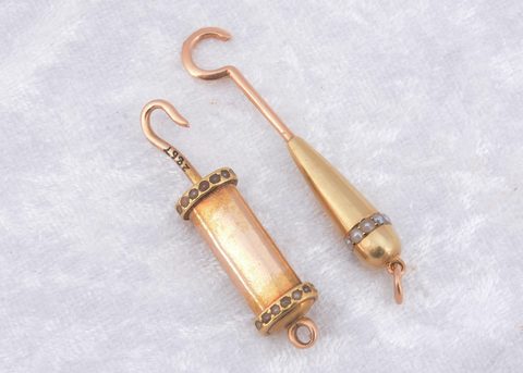 A 19th Century yellow metal and seed pearl decorated sliding button hook
