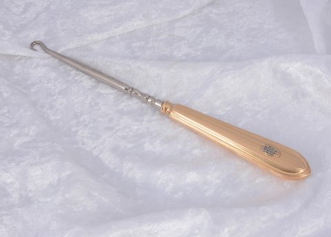 A Cartier 14k marked gold handled button hook