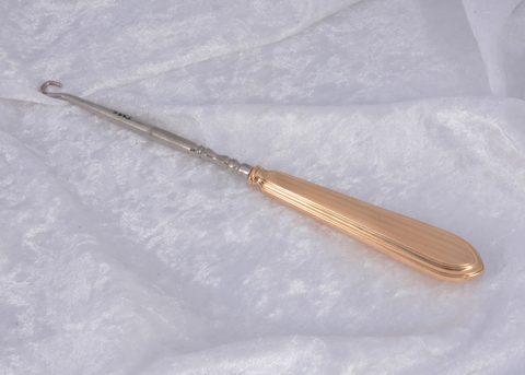 A Cartier 14k marked gold handled button hook