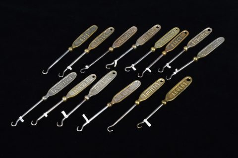 A collection of 19th Century steel and brass flattened souvenir button hooks