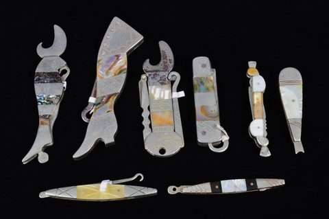 A collection of abalone and mother of pearl handled retractable handbag or pocket button hooks