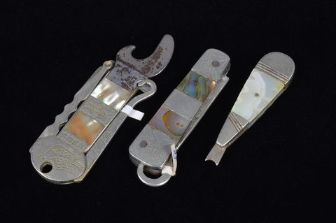 A collection of abalone and mother of pearl handled retractable handbag or pocket button hooks