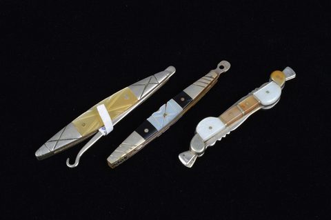 A collection of abalone and mother of pearl handled retractable handbag or pocket button hooks