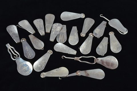 A collection of advertising steel combination button hook and shoehorns