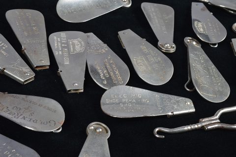 A collection of advertising steel combination button hook and shoehorns