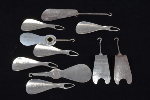 A collection of advertising steel combination button hook or loop and shoehorns