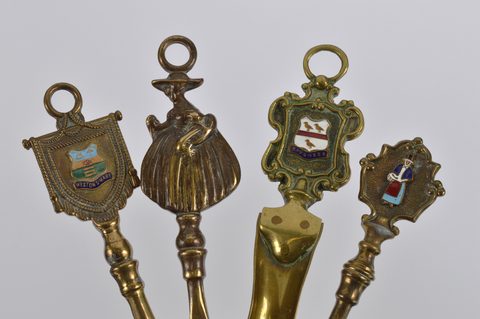 A collection of eleven brass souvenir shoehorns