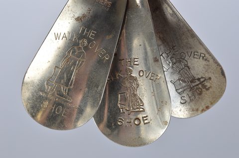 A collection of eleven steel shoehorns