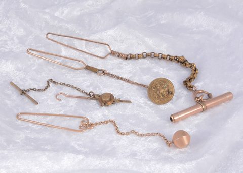 A collection of gilt metal novelty lapel button hooks