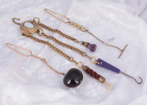 A collection of gilt metal novelty lapel button hooks