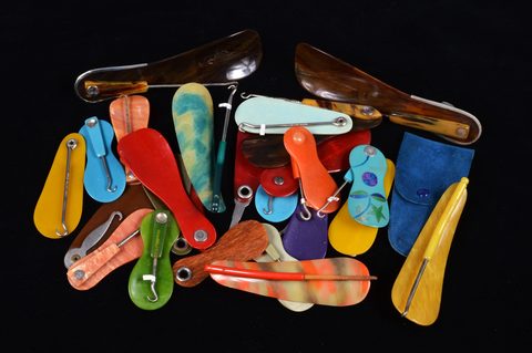 A collection of hinged swivel plastic combination shoehorn and button hooks