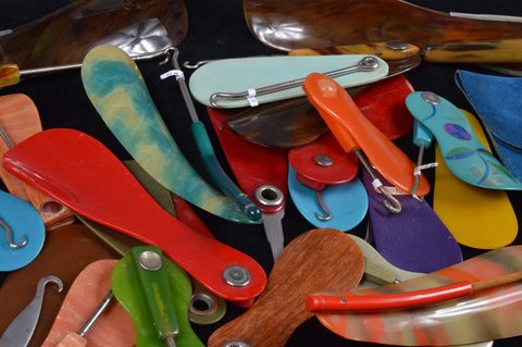A collection of hinged swivel plastic combination shoehorn and button hooks