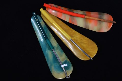 A collection of hinged swivel plastic combination shoehorn and button hooks