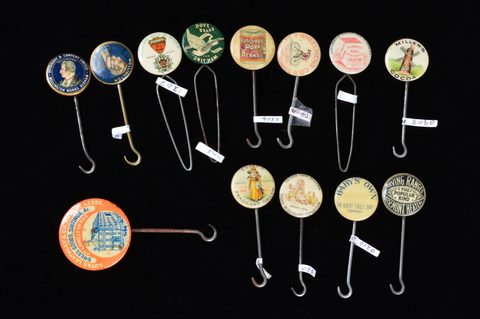 A collection of late 19th and early 20th Century advertising button hooks and loops