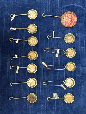 A collection of late 19th and early 20th Century advertising button hooks and loops