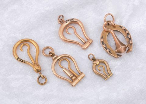 A collection of miniature folding horseshoe shaped button hooks