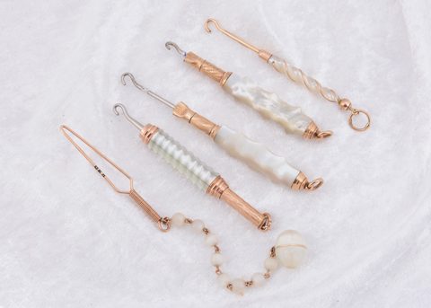 A collection of mother of pearl and gilt metal button hooks
