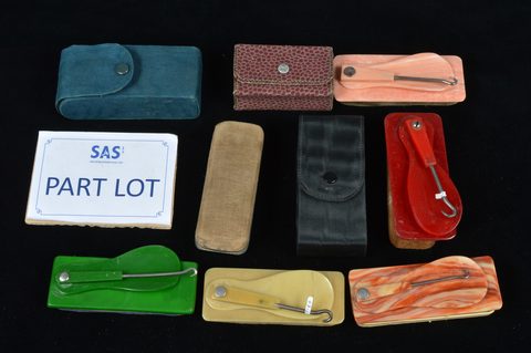 A collection of plastic combination swivel hinged button hooks