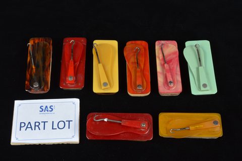 A collection of plastic combination swivel hinged button hooks