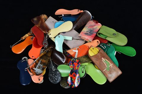 A collection of plastic loop attached button hooks and shoehorns