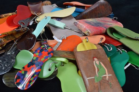 A collection of plastic loop attached button hooks and shoehorns