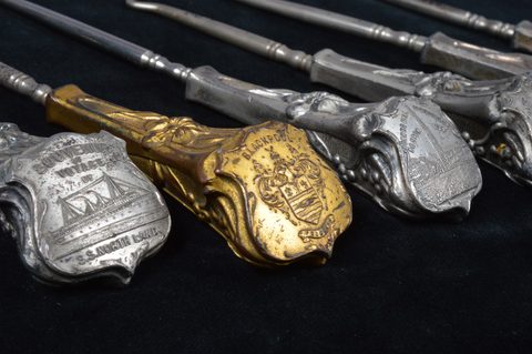 A collection of souvenir button hooks