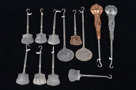 A collection of souvenir button hooks