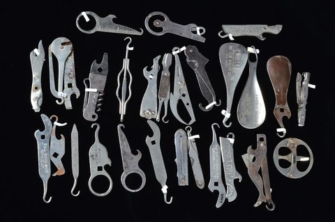A collection of stainless stell advertising multi tools containing button hooks