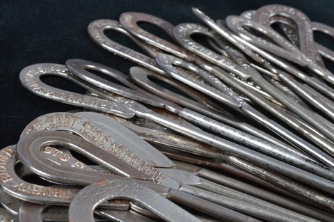 A collection of steel advertising button hooks