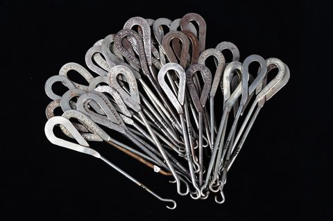 A collection of steel advertising button hooks