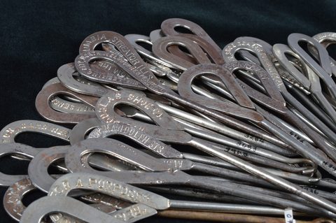 A collection of steel advertising button hooks