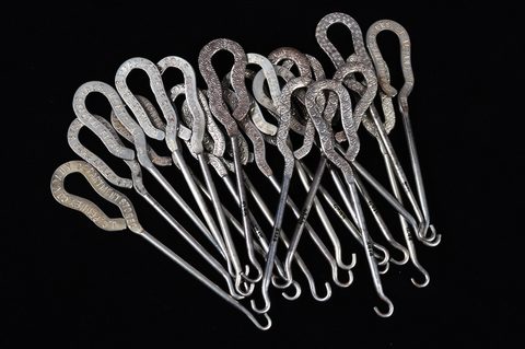 A collection of steel advertising button hooks