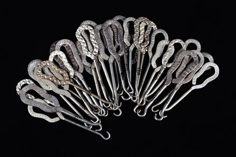 A collection of steel advertising button hooks