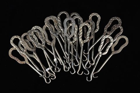 A collection of steel advertising button hooks