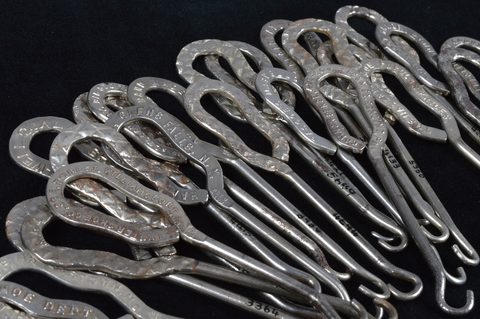 A collection of steel advertising button hooks