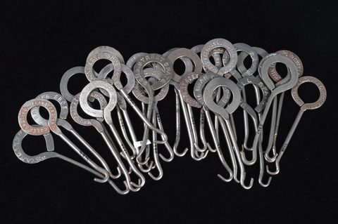 A collection of steel advertising button hooks