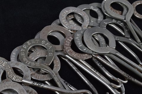 A collection of steel advertising button hooks