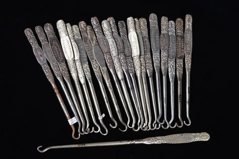 A collection of steel advertising button hooks