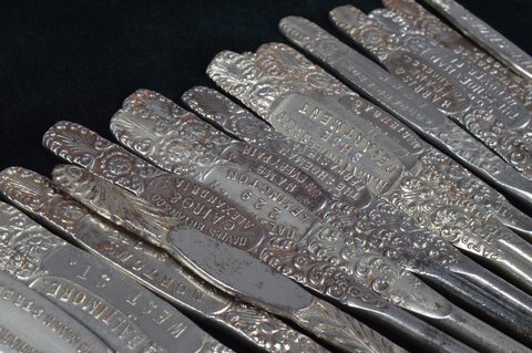 A collection of steel advertising button hooks
