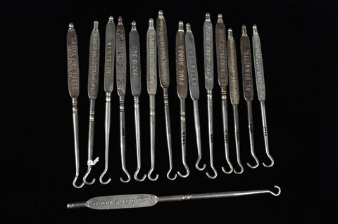 A collection of steel advertising button hooks