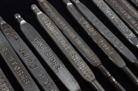 A collection of steel advertising button hooks