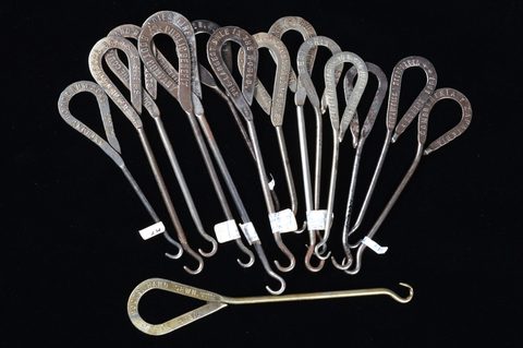 A collection of steel advertising  button hooks