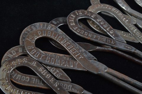 A collection of steel advertising  button hooks