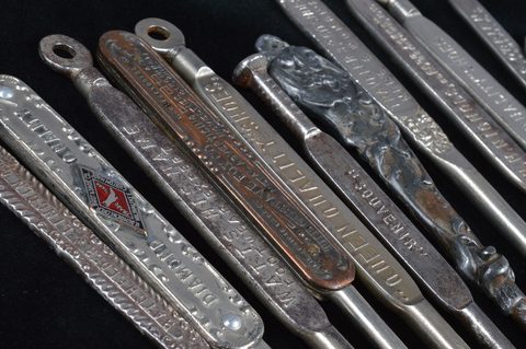 A collection of steel advertising  button hooks