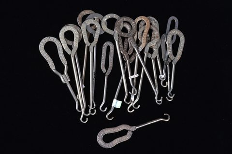 A collection of steel advertising  button hooks