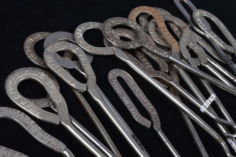 A collection of steel advertising  button hooks